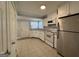 Bright kitchen featuring white cabinets, tile floor, and a stainless steel refrigerator at 1165 Fair Sw St, Atlanta, GA 30314
