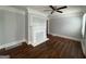 Bright living room featuring a decorative fireplace, ceiling fan, and gleaming hardwood floors at 1165 Fair Sw St, Atlanta, GA 30314