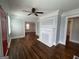 Open living room with a decorative fireplace, freshly painted walls, and wood flooring at 1165 Fair Sw St, Atlanta, GA 30314