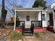 Inviting covered porch with black railing and trim, offering a cozy outdoor space at 1165 Fair Sw St, Atlanta, GA 30314