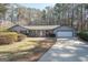 Inviting home with a long driveway, well-manicured lawn, and an attached garage at 120 Fountain Head, Peachtree City, GA 30269