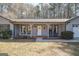 Charming home featuring a welcoming front porch with rocking chairs and a cozy seating area at 120 Fountain Head, Peachtree City, GA 30269
