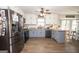 Updated kitchen with stainless steel appliances, granite counters, and a view into breakfast nook at 120 Fountain Head, Peachtree City, GA 30269