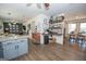 Open-concept kitchen with a view into the living area, featuring floating shelves and center island at 120 Fountain Head, Peachtree City, GA 30269