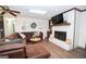 Cozy living room with a brick fireplace, mounted TV, and comfortable leather sectional at 120 Fountain Head, Peachtree City, GA 30269
