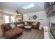 Bright living room with a skylight, brick fireplace, wood floors, and comfortable seating at 120 Fountain Head, Peachtree City, GA 30269