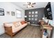 Living room with wood-look flooring, mounted television and futon-style sofa at 120 Fountain Head, Peachtree City, GA 30269