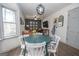 Cozy living room featuring a modern light fixture, dining table and bay window at 120 Fountain Head, Peachtree City, GA 30269
