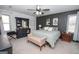 This is a relaxing primary bedroom that features a ceiling fan, bench, light gray walls and neutral carpet at 120 Fountain Head, Peachtree City, GA 30269