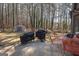 The backyard patio features grilling and dining areas, overlooking a serene wooded landscape at 120 Fountain Head, Peachtree City, GA 30269
