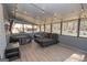 Relaxing enclosed sunroom with plenty of sunlight, string lights, modern furniture, and hot tub at 120 Fountain Head, Peachtree City, GA 30269