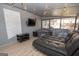 Cozy screened-in sunroom with modern furniture, TV, string lights, and a relaxing hot tub at 120 Fountain Head, Peachtree City, GA 30269