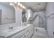 Traditional bathroom featuring a double vanity, large mirrors, and a shower/tub combo with a stylish curtain at 2808 Autumn Lake Ln # D/6, Decatur, GA 30034