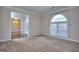 Bedroom featuring neutral carpet, trim and a large window letting in natural light at 2808 Autumn Lake Ln # D/6, Decatur, GA 30034