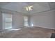 Spacious carpeted main bedroom with ceiling fan, large windows, and a neutral color scheme at 2808 Autumn Lake Ln # D/6, Decatur, GA 30034