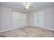 Carpeted bedroom featuring double door closet, natural light from the window, and neutral walls at 2808 Autumn Lake Ln # D/6, Decatur, GA 30034