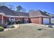 Single-story brick home featuring an attached two-car garage and well-maintained front yard at 2808 Autumn Lake Ln # D/6, Decatur, GA 30034