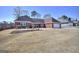 Charming brick home featuring a well-maintained lawn, mature trees, and an attached two-car garage at 2808 Autumn Lake Ln # D/6, Decatur, GA 30034
