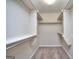 Walk-in closet provides ample storage with shelving and hanging rods at 2808 Autumn Lake Ln # D/6, Decatur, GA 30034