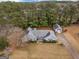 An aerial view of a home with a detached garage and well-maintained landscape in a serene wooded setting at 230 Acorn Ct, Mcdonough, GA 30253