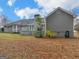 Backyard with well-maintained lawn, mature trees, and a wooden deck, great for outdoor gatherings and relaxation at 230 Acorn Ct, Mcdonough, GA 30253