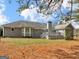 Charming backyard featuring a well-maintained lawn, mature trees, and a deck, perfect for outdoor entertaining and relaxation at 230 Acorn Ct, Mcdonough, GA 30253