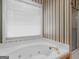 Bathroom showcasing a tub with jets and a window, and a shower in the background at 230 Acorn Ct, Mcdonough, GA 30253
