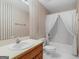 Cozy bathroom with striped wallpaper, white toilet, and shower with curtain at 230 Acorn Ct, Mcdonough, GA 30253