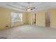 Large main bedroom featuring a ceiling fan, carpeting, and natural light at 230 Acorn Ct, Mcdonough, GA 30253