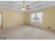 Bedroom featuring a ceiling fan, carpeted floors, and lots of natural light at 230 Acorn Ct, Mcdonough, GA 30253
