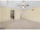 Large bedroom featuring a carpeted floor, ensuite bathroom, and ceiling fan at 230 Acorn Ct, Mcdonough, GA 30253