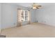 Bright bedroom featuring a ceiling fan, window with blinds and neutral carpet at 230 Acorn Ct, Mcdonough, GA 30253