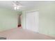 Light and airy bedroom with green walls, neutral carpet and view to another room at 230 Acorn Ct, Mcdonough, GA 30253