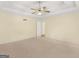 Bedroom with carpeted flooring, ceiling fan, and an entrance to the bathroom at 230 Acorn Ct, Mcdonough, GA 30253