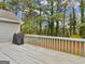 Wooden deck area with grill, railing, and view of wooded backyard at 230 Acorn Ct, Mcdonough, GA 30253
