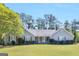 Charming single-story home with light gray siding, a green lawn, and a beautifully landscaped front yard at 230 Acorn Ct, Mcdonough, GA 30253