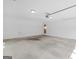 A spacious, clean garage with white walls and ceiling features overhead lighting and ample storage space at 230 Acorn Ct, Mcdonough, GA 30253