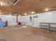 Spacious garage featuring pegboard walls for organization, overhead lighting, and ample storage space for tools and equipment at 230 Acorn Ct, Mcdonough, GA 30253