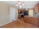 Well-lit kitchen with wood cabinets, black appliances, and open floor plan at 230 Acorn Ct, Mcdonough, GA 30253