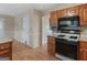 Functional kitchen featuring wood cabinets, gas range, and convenient layout at 230 Acorn Ct, Mcdonough, GA 30253