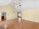 Bright living room with ceiling fan, laminate flooring, and views into other rooms at 230 Acorn Ct, Mcdonough, GA 30253