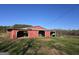 Exterior view of a barn featuring multiple open bays and storage space at 1761 Reavesville Rd, Bowdon, GA 30108