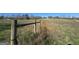 Rustic wooden fence bordering a grassy field, showcasing the property's boundary and countryside charm at 1761 Reavesville Rd, Bowdon, GA 30108