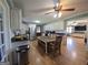 Bright, open kitchen with white cabinets, stainless appliances, a table, and hardwood floors at 1761 Reavesville Rd, Bowdon, GA 30108