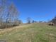 Expansive land under a clear blue sky offers endless possibilities for development or recreation at 1761 Reavesville Rd, Bowdon, GA 30108