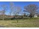 Scenic view of a large lot with mature trees, pasture, and an outbuilding at 1761 Reavesville Rd, Bowdon, GA 30108