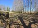 Scenic property view featuring a rustic wooden fence line and mature trees in a natural setting at 1761 Reavesville Rd, Bowdon, GA 30108
