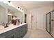 Modern bathroom featuring a glass enclosed shower, dual sink vanity, and modern fixtures at 10414 Trellis Lane (Lot 36), Hampton, GA 30228