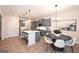 Modern kitchen featuring stainless steel appliances, an island with seating, and a stylish dining area at 10414 Trellis Lane (Lot 36), Hampton, GA 30228