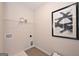 Bright laundry room with tile flooring, storage shelf, and modern decor at 10414 Trellis Lane (Lot 36), Hampton, GA 30228